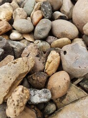 abstract Textured background with round pebble stones. Vacation holiday recreation on beach concept. High quality photo. Fragment with a texture of rock.