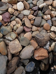 abstract Textured background with round pebble stones. Vacation holiday recreation on beach concept. High quality photo. Fragment with a texture of rock.