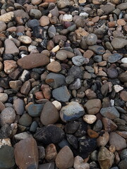 abstract Textured background with round pebble stones. Vacation holiday recreation on beach concept. High quality photo. Fragment with a texture of rock.