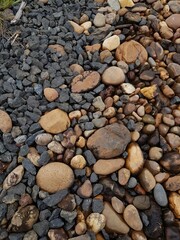 abstract Textured background with round pebble stones. Vacation holiday recreation on beach concept. High quality photo. Fragment with a texture of rock.