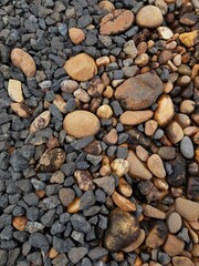abstract Textured background with round pebble stones. Vacation holiday recreation on beach concept. High quality photo. Fragment with a texture of rock.