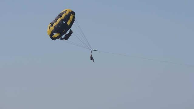 Tourist enjoy the parasailing during summer holidays at seaside