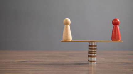 Wooden human figure, coins on the table.