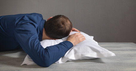 Obraz premium Tired caucasian man sleep at workplace.