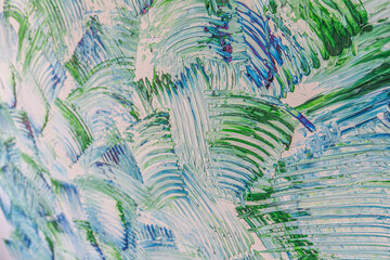 Blue and green grunge paint on wall. Hard paint strokes of blue and green color.