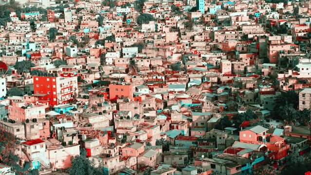 Life in the slums of the Dominican Republic. Social injustice. Poverty in dilapidated houses in a dirty quarter of Santo Domingo. Rusty roofs of poor houses, aerial view. The video is tinted.