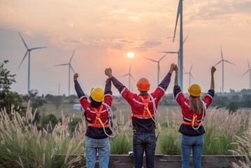 engineer technician team raise joy hand for success happiness at wind power plant machine . silhouette Group of colleague technician professional worker discussion maintenance electronic wind turbine - obrazy, fototapety, plakaty