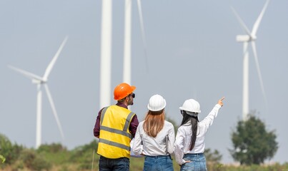 engineer team inspection check control wind power machine construction installation in wind energy factory. technician professional worker discussion check for repair maintenance  wind turbine