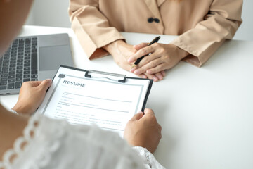 Business people hold a resume and talk to job applicants for job interviews about careers and Their...