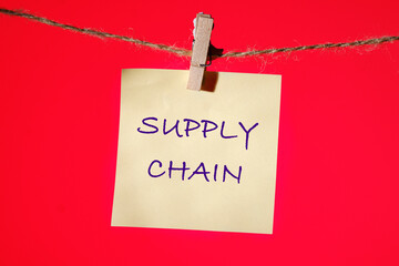 The words Supply Chain written on a yellow sticker on a rope with a clothespin on a red one