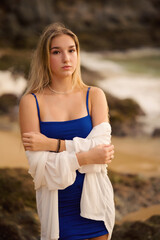 Young beautiful teenager girl with long hair european model posing on the sunset beach