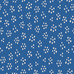 Cute white hand drawn polka dot on a blue  background.  Abstract brush spots seamless pattern.  Simple vector design for fabric, wallpaper, textile, wrapping paper, packaging.
