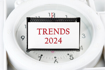 The evaluation methods, popular topics, and new trends in business. TRENDS 2024 written on a white business card