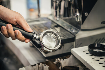 close up od barista hands using coffee machine