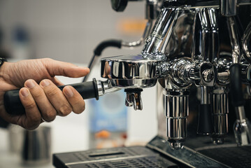 close up of a barista making coffee with a coffee machine