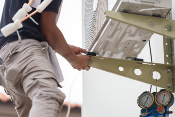 Repairman service for repair and maintenance of air conditioners, Technician man install new air...