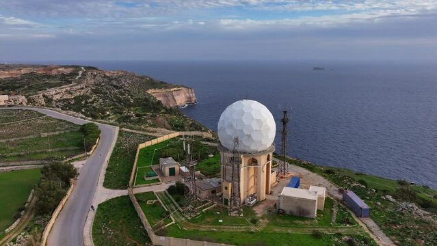 Aerial panoramic drone footage of the Mediterranean Sea from the Dingli Cliffs (Rdum ta' Had-Dingli) with radar antenna in the foreground. Malta, Mediterranean.
