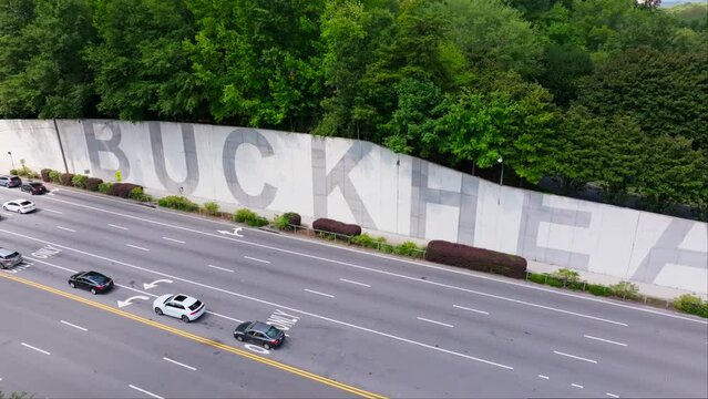 Path400 Park, Park, Buckhead Wall And Traffic In Atlanta, Georgia, USA. - aerial pullback