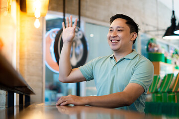 Asian man friendly Greeting at the Modern Cafe