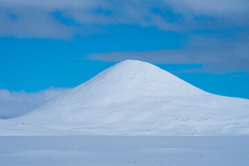 Fototapeta na wymiar Muen Mountain from the area of Venabygdsfjellet Mountains with the Rondane National Park in late winter.