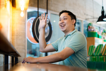 Asian man friendly Greeting at the Modern Cafe