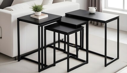 A minimalist nesting table set with black finish  varying heights  space saving design  and practical versatility - obrazy, fototapety, plakaty