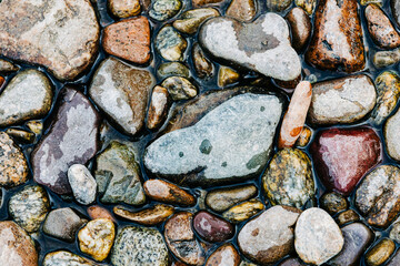 River rocks partially wet in water
