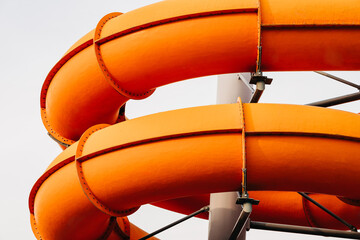 Two loops of orange water slide tubes
