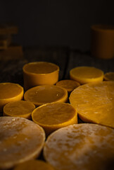 Round yellow beeswax pieces isolated. Pure beeswax for crafts