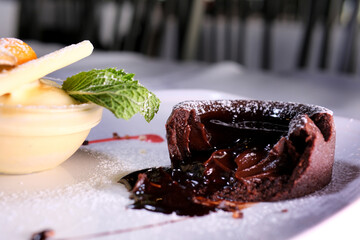  Chocolate fondant with strawberries and spoon on plate, isolated on white background, top view