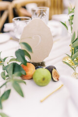 Fototapeta premium Chic wedding table number with fruit accents