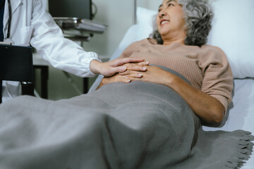 Female doctors shake hands with patients encouraging each other To offer love, concern, and encouragement while checking the patient's health. Concept Health care and Social Security