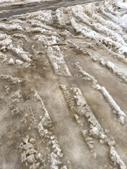 Traces from car wheels in the snow in winter as a background