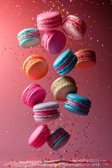 Gartenposter Dynamic array of colorful macarons levitating mid air against a pink background with festive sprinkles falling © MergeIdea