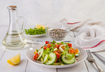 Salad of fresh cucumbers, celery, sweet peppers, herbs and pumpkin seeds, sunflowers, sesame seeds with olive oil. Healthy vegetarian, vegan food. Italian Cuisine
