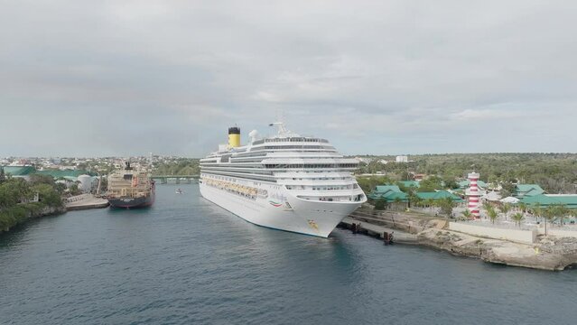 Cruise ship moored in La Romana tourist port, Dominican Republic. Aerial orbiting and sky for copy space. FIRST PART