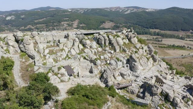 Ruins Of Perperikon On Rocky Hill In Eastern Rhodopes. Bulgaria. ascending drone shot