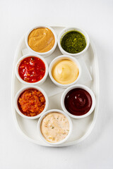 different sauces on the white, top view