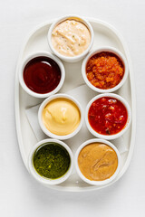 different sauces on the white, top view