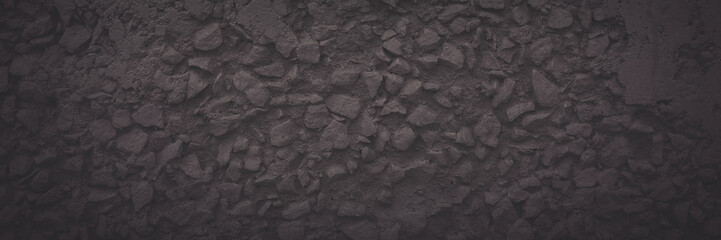 Texture of the old wall. Rough grungy surface of plastered concrete wall with spots, cracks, noise and grain. Faded dark wide panoramic background for design. Shaded vintage texture with vignette.