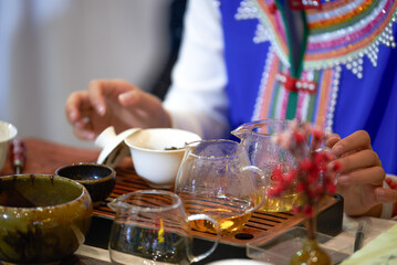 A tea sommelier is making tea for a customer