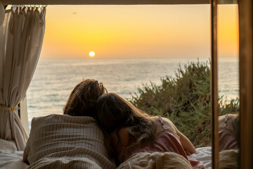 Couple Embracing Sunrise From Van by the Sea