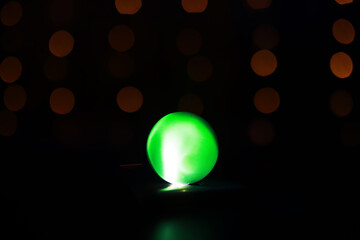 Background with glowing ball and bokeh. Ball for predictions. Clairvoyant ball.