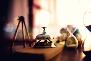 Vintage bell stands on wooden counter to attract attention