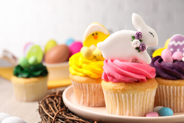 Tasty cupcakes with Easter decor on table