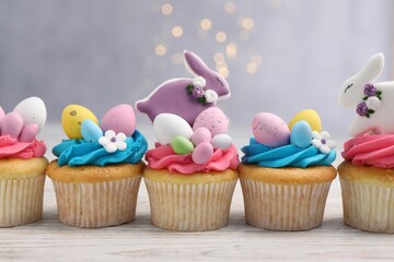 Tasty decorated Easter cupcakes on wooden table