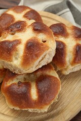 Tasty hot cross buns on table, closeup