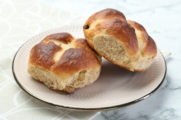 Hot cross buns on white marble table