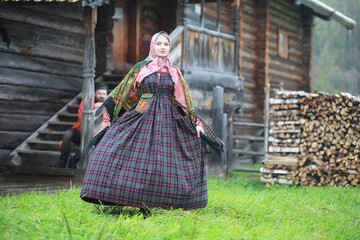 Traditional Slavic rituals in the rustic style. Outdoor in summer. Slavic village farm. Peasants in elegant robes.