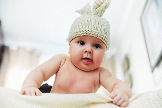 The little baby is lying on the crib. Newborn.